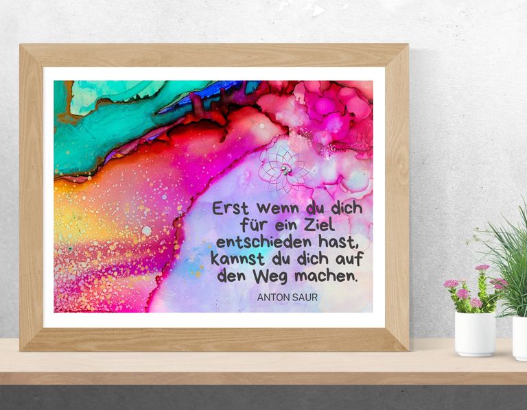 Bunter Kunstdruck mit fließenden farbenfrohen Mustern in Pink, Rot, Türkis und Orange, darauf ein deutsches Zitat von Anton Saur über Zielsetzung.